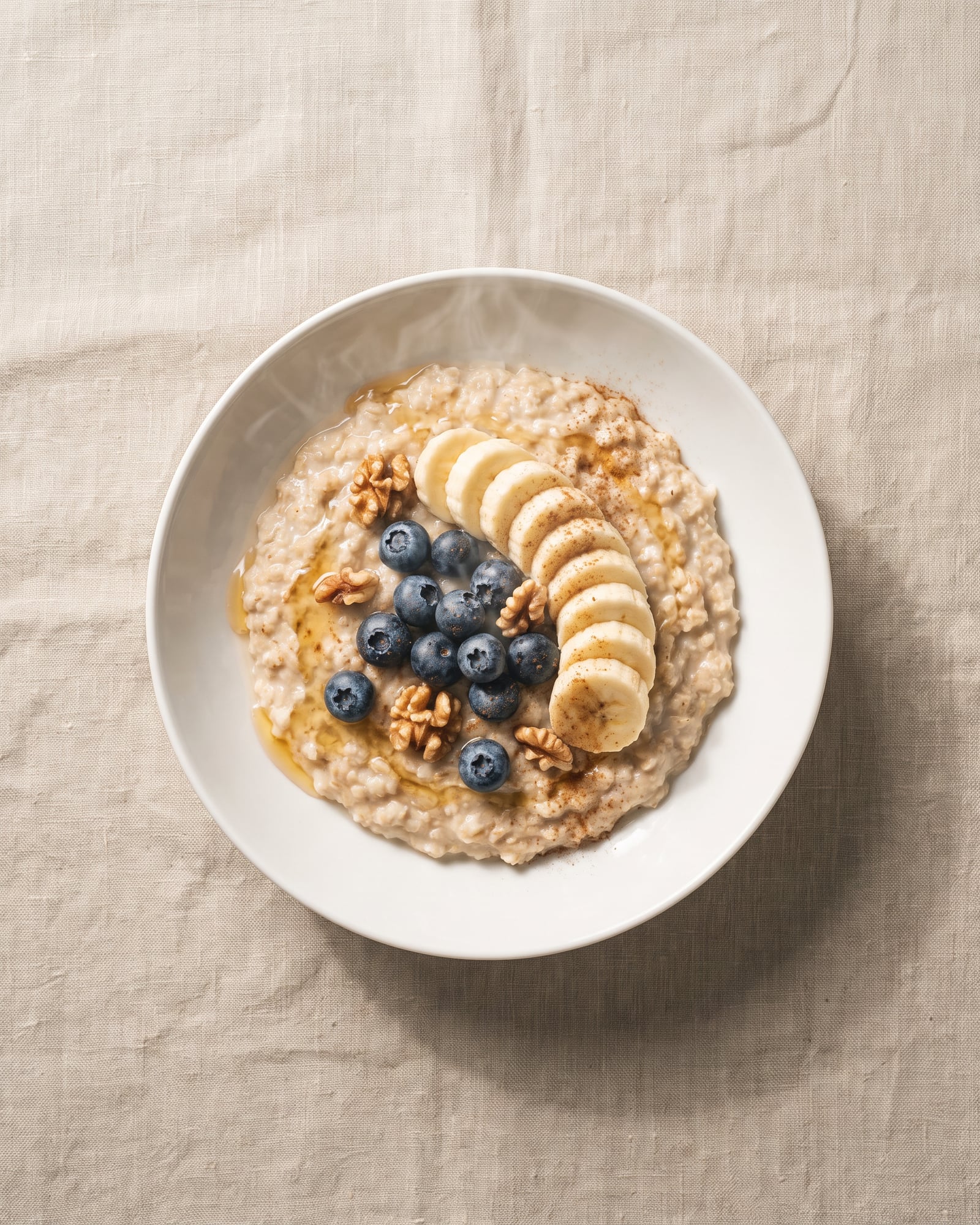 Porridge with sliced banana, blueberries, walnuts, honey and cinnamon.