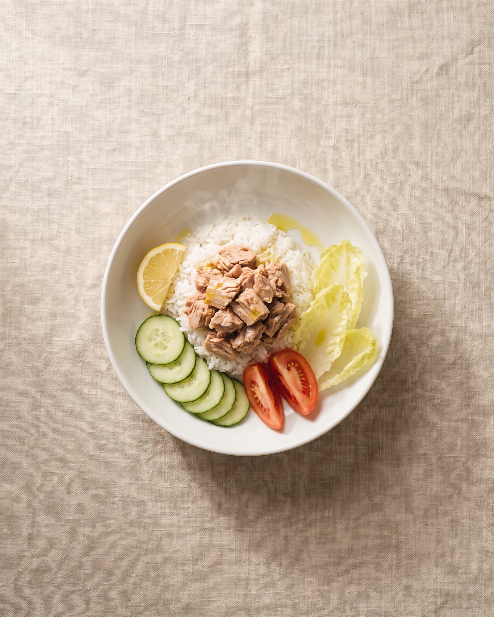 Tuna and white rice with cucumber, tomato, baby gem lettuce, lemon and olive oil.